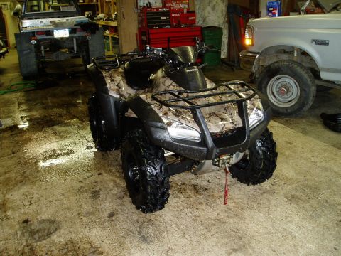 2000 Ford E350 - A four-wheel all-terrain vehicle is parked indoors on a concrete floor.
