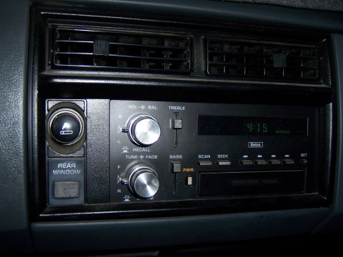 1991 Ford Bronco - Close-up of a car's dashboard, showing the radio controls and air conditioning vents.