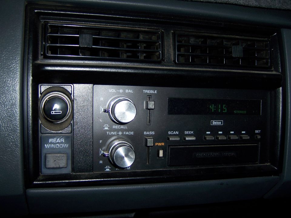 Dashboard with radio, air vents, cigarette lighter, and rear window button
