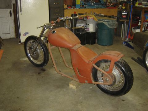 1994 Ford Probe - Custom motorcycle in a workshop, showing its frame, tank, and seat.