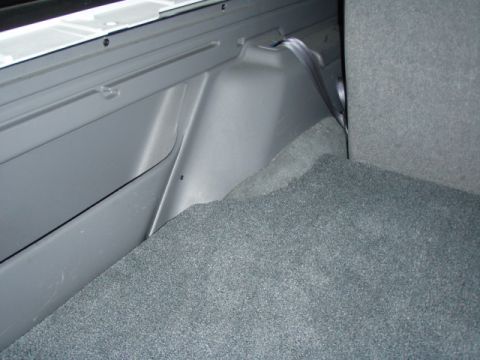 1996 Ford Bronco - Rear cargo area of a 1996 Ford Bronco, showing carpet and interior paneling.