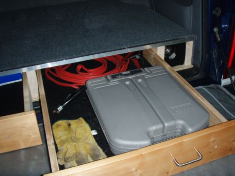 1996 Ford Bronco - Enough room for a cheap tool kit, cables and whatever else. The side bin holds my hitch securely.