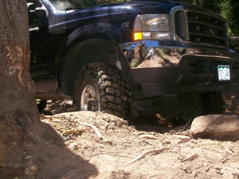 1978 Ford Bronco - Ford F-250 Super Duty navigating rough terrain with large off-road tires.