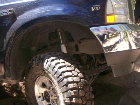 1978 Ford Bronco - Close-up view of the front wheel well and fender of a Ford F-250 Super Duty truck.