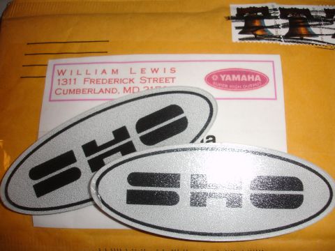 1990 Ford Taurus - Two SHO emblems are shown on top of an envelope with a return address.