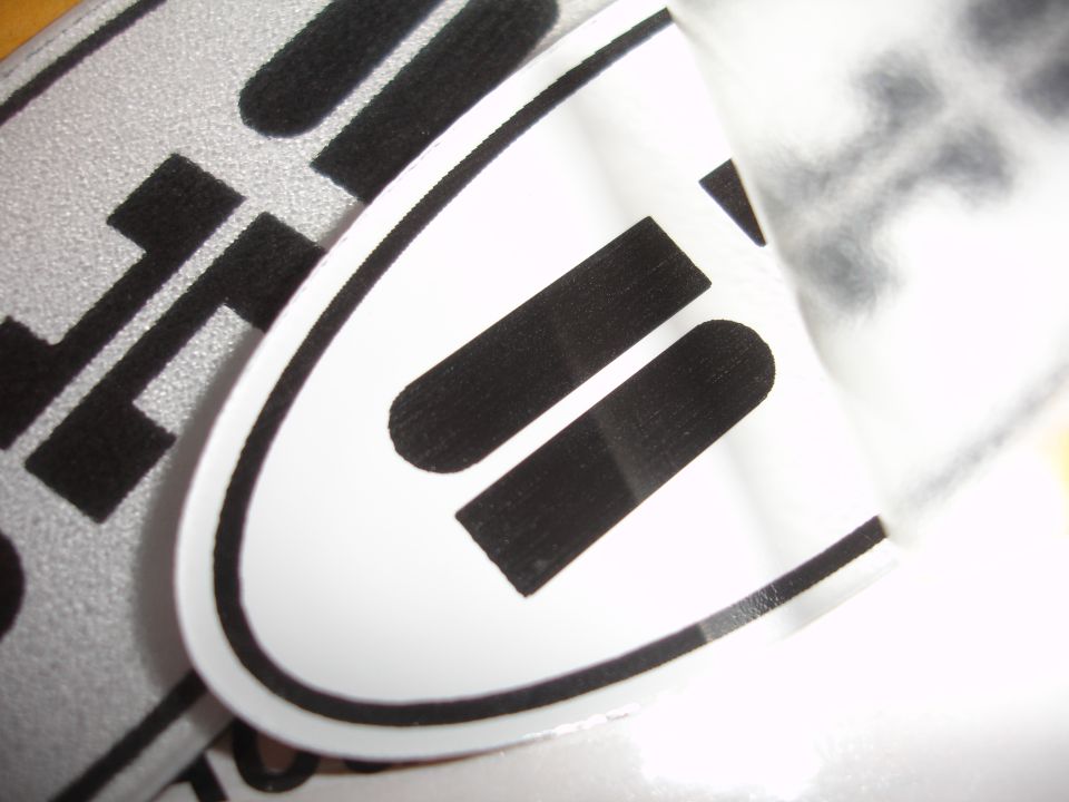 Black stripes on white oval emblem