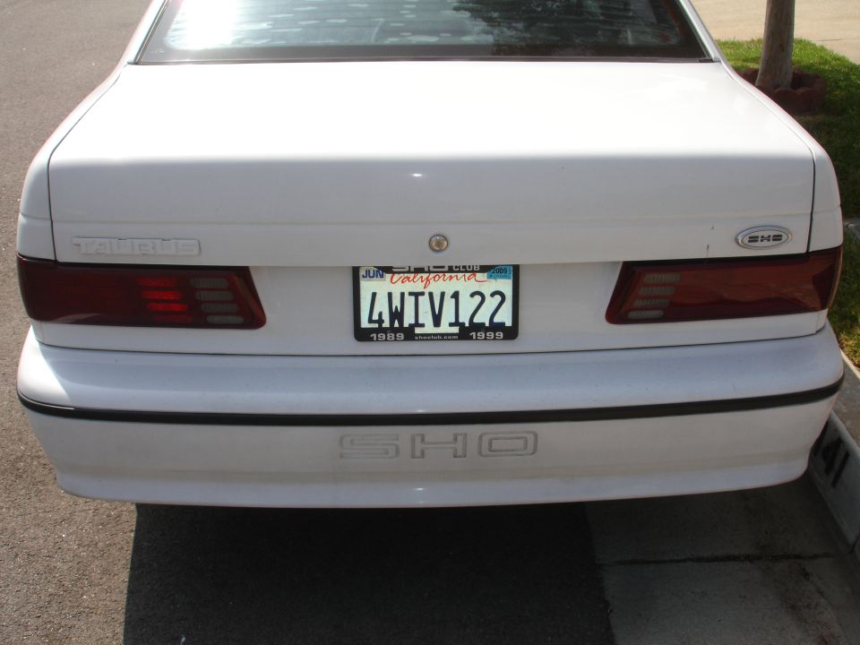 Rear of a white Ford Taurus SHO with a California license plate reading 4WIV122