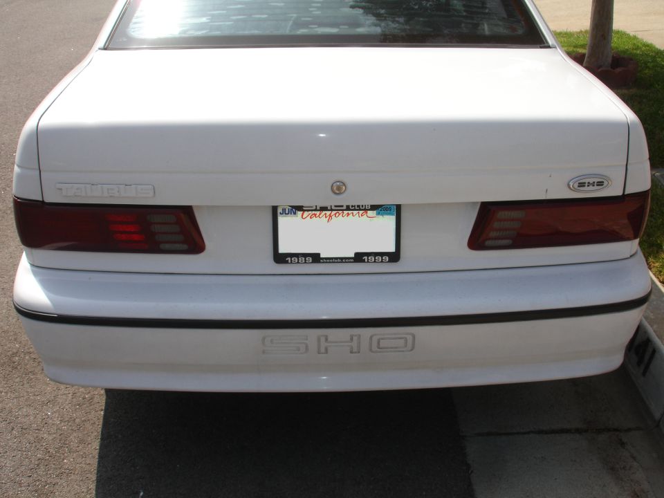 Rear of a white 1989 Ford Taurus SHO with a California license plate
