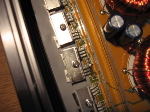 1992 Ford Crown Victoria - This image shows a close-up view of an electronic circuit board, capacitors, coils, and heat sinks, with visible text from Supermotors.net.