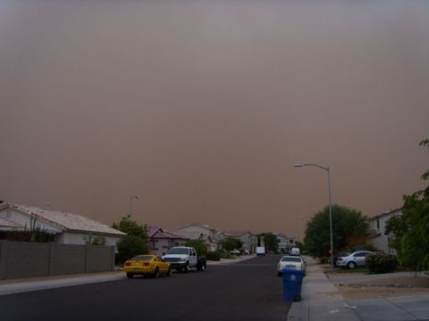 1978 Ford Bronco - Dust storm blankets a neighborhood, reducing visibility and covering vehicles.