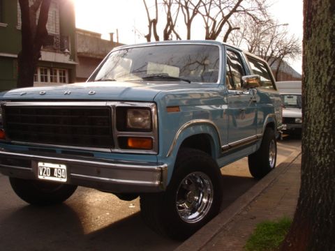 1980 Ford Bronco - A light blue Ford Bronco is parked on a residential street during the day.