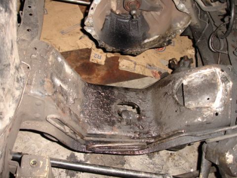 1980 Ford Bronco - Close-up of a vehicle's undercarriage, focusing on the frame and transmission components.