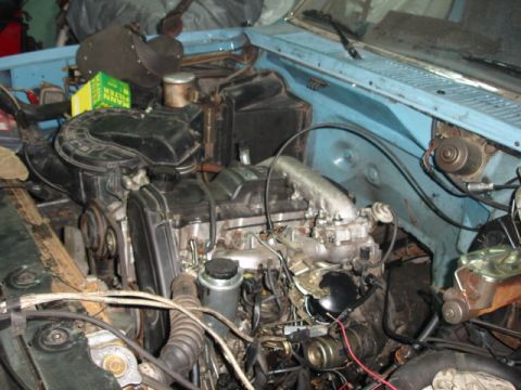 1980 Ford Bronco - Close-up view of the engine bay, showing various mechanical parts and the air filter assembly.