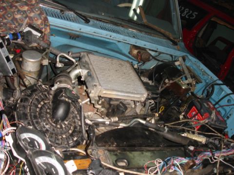 1980 Ford Bronco - The engine bay is filled with various components, including an intercooler and a complex wiring harness.