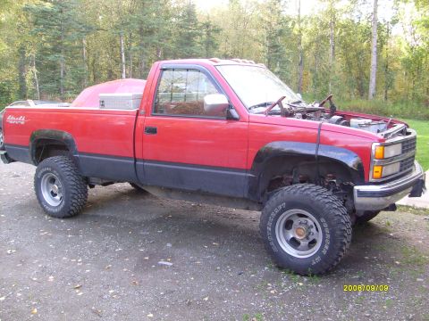 1984 Chevrolet Blazer - Red pickup truck with hood open, parked outdoors. Appears to be a 1990s model.