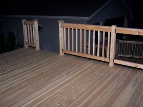 1986 Ford Bronco - A newly constructed wooden deck with railings is shown at night, with a house in the background.