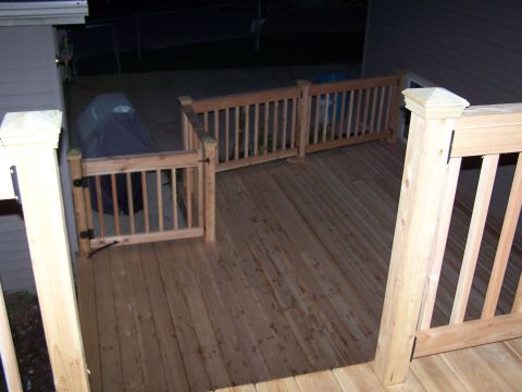 1986 Ford Bronco - A wooden deck is shown with a covered grill and railings, a watermark at the bottom right.