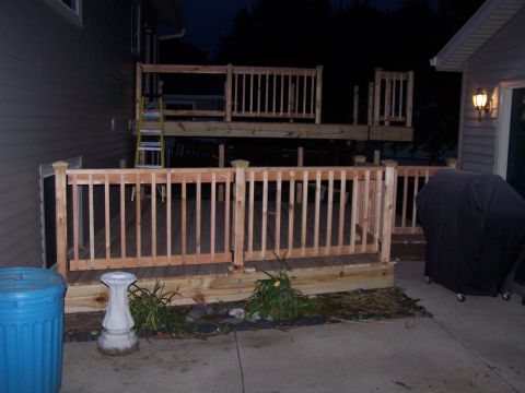 1986 Ford Bronco - A wooden deck is under construction, railings and a ladder leaning against the structure.