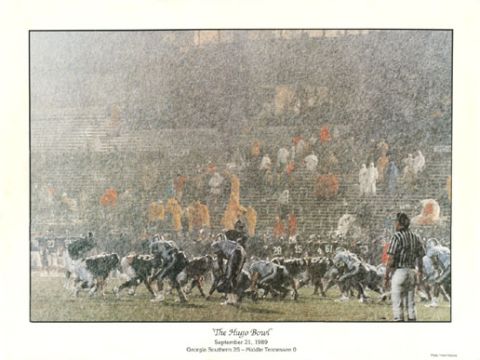 1995 Ford Bronco - A football game is played in heavy rain, with players on the field and spectators in the stands.