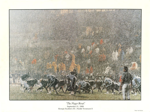Football game in the rain with spectators in the stands