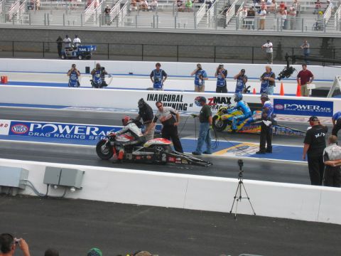 1992 Ford Mustang - NHRA drag racing event with multiple motorcycles and crew preparing for a race.