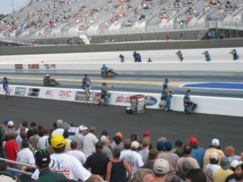 1992 Ford Mustang - Drag racing event with spectators in the foreground and racers on the track.