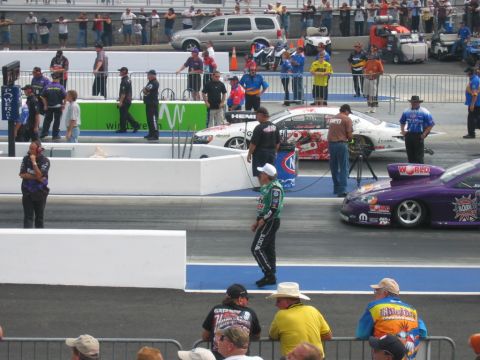 1992 Ford Mustang - A drag racing event with multiple vehicles and spectators in the background.
