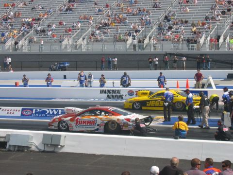 1992 Ford Mustang - Drag racers prepare for a race at Concord USA Dragway, with spectators in the stands.