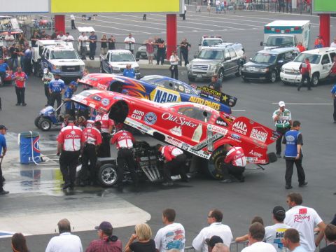 1992 Ford Mustang - Crew members attend to drag racing cars at a track event.