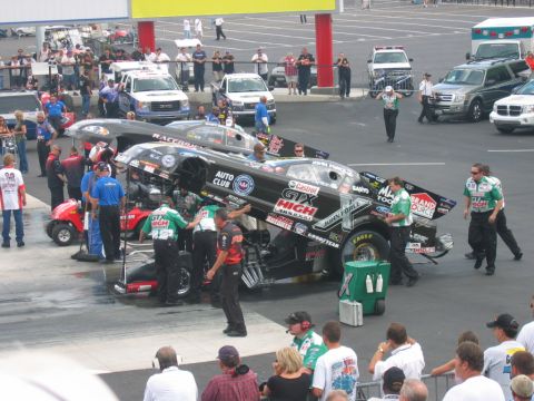 1992 Ford Mustang - Crew members attend to drag racing cars at a competition event.