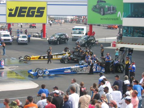 1992 Ford Mustang - Drag racing cars are lined up on the track with spectators watching.