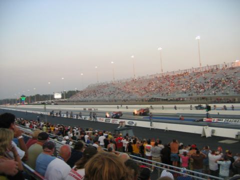 1992 Ford Mustang - Drag racing event with packed grandstands under a hazy sky.