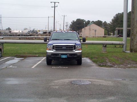 1978 Ford Bronco - A blue Ford F-250 Super Duty truck is parked in a lot on an overcast day.