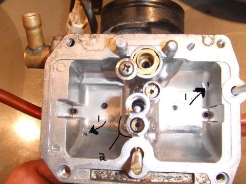 1995 Ford Mustang - A detailed view of a carburetor's internal workings, with markings indicating specific areas for repair or identification.