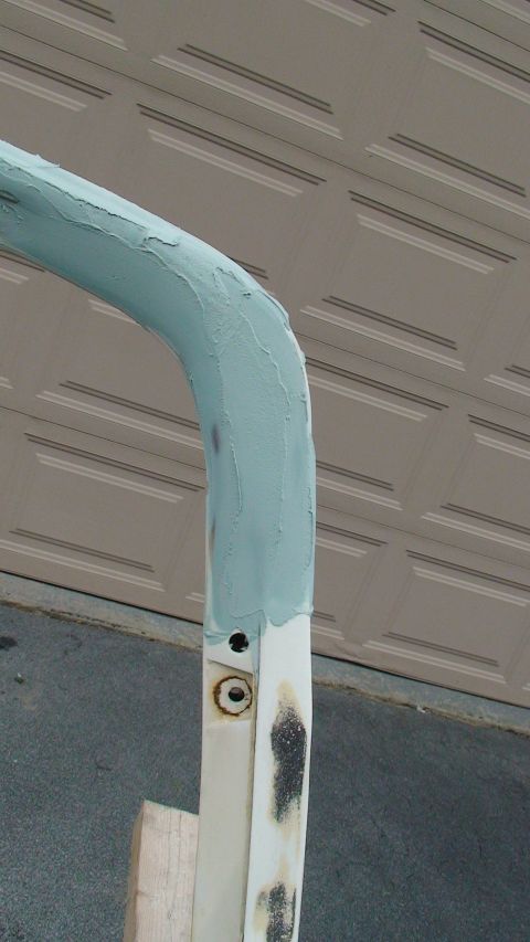 1979 Ford Bronco - A metal bar, partially covered in body filler, is shown with a white bracket and visible rust.
