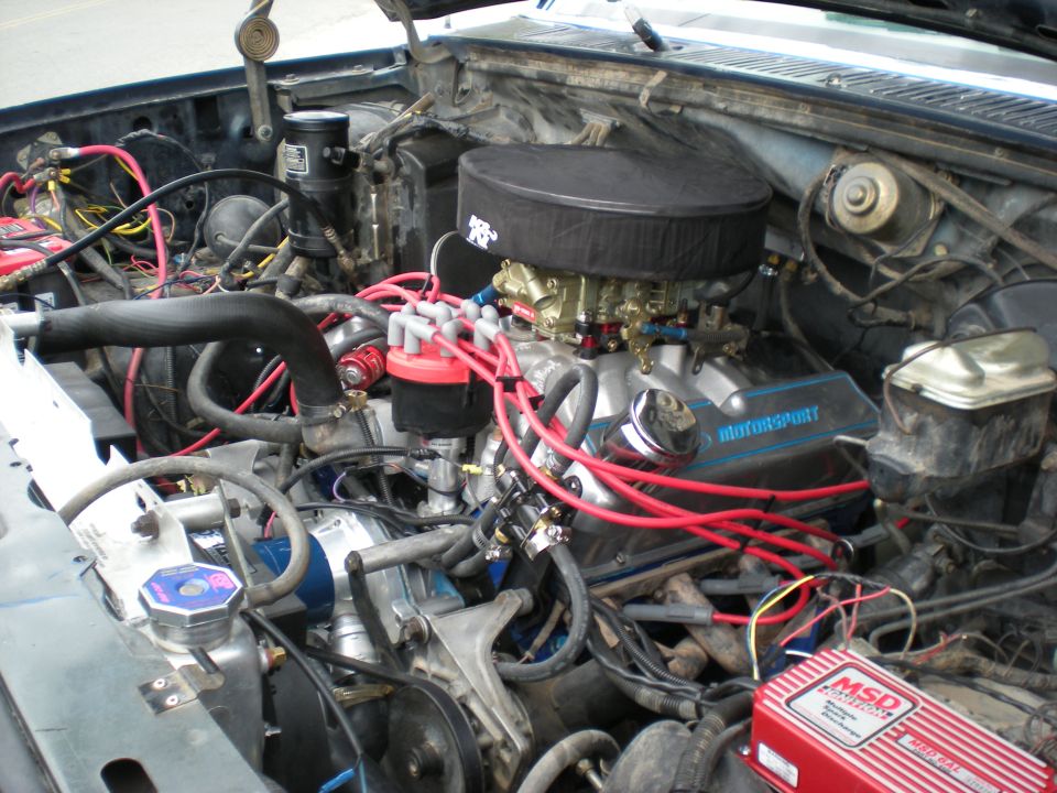 Engine bay showing a V8 engine with K&N air filter, MSD ignition box, and various hoses and wires