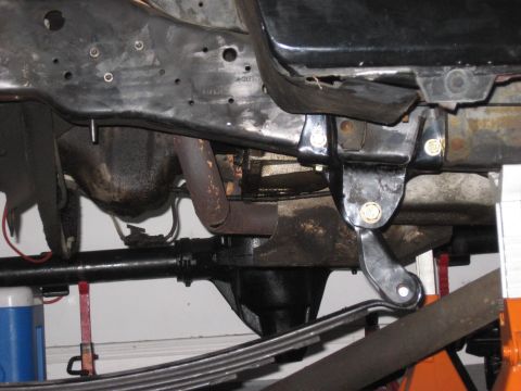 1991 Ford Bronco - Close-up of the undercarriage, focusing on the leaf spring and suspension mounting hardware.