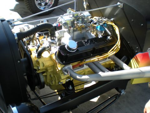 1974 Ford Ranchero - Close-up view of a modified V8 engine, a bright yellow engine block and custom exhaust headers.