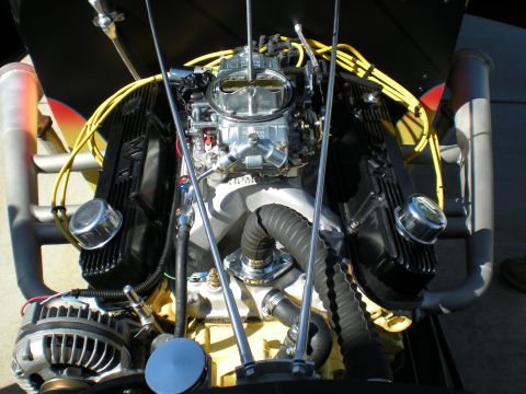 1974 Ford Ranchero - Close-up view of a modified engine with custom exhaust pipes and visible alternator.