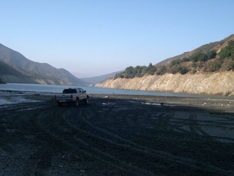 2007 Toyota FJ Cruiser - A pickup truck sits by a lake on a clear day, with mountains rising in the distance.