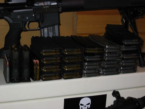 1996 Ford Bronco - A close-up view of multiple firearm magazines loaded with cartridges, and a portion of a firearm is visible at the top. A sticker with a sk…