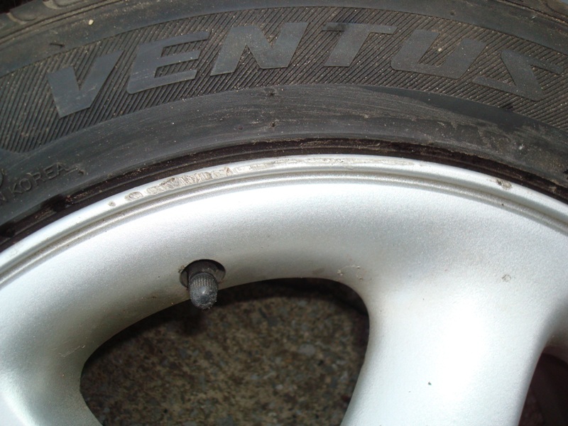 Close-up of a tire with "VENTUS" text and a silver alloy wheel with a valve stem.