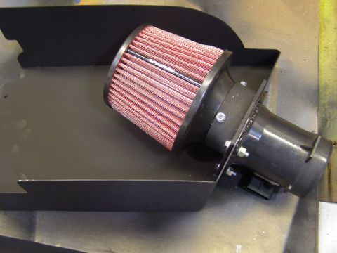 2003 Ford Crown Victoria - A black metal air intake box is shown with a red and white conical air filter attached to a black plastic intake tube. The intake tube has…