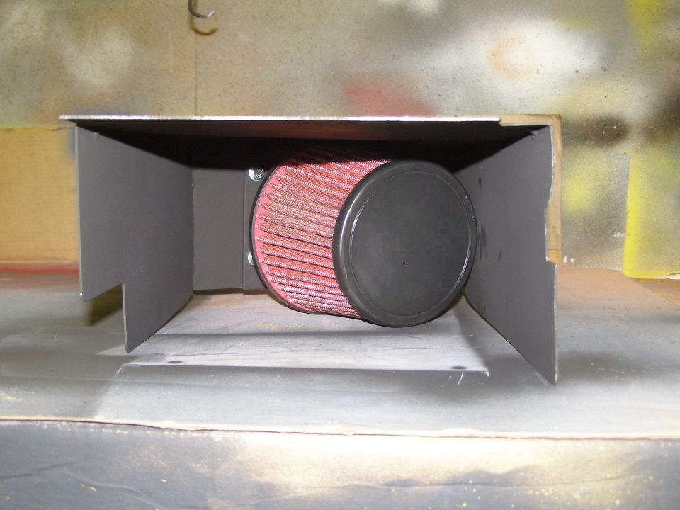 Custom air intake system with red cone filter in a gray metal box.