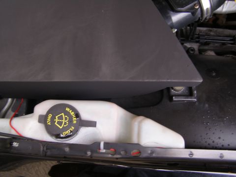 2003 Ford Crown Victoria - The black cap on the white washer fluid reservoir in a 2003 Ford Crown Victoria is labeled "WASHER FLUID ONLY" with a windshield washer ico…