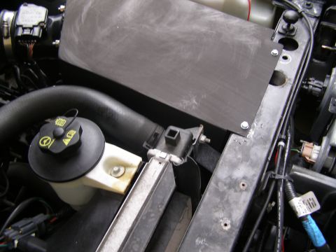 2003 Ford Crown Victoria - Engine bay components, including hoses and electrical connectors, are visible in this close-up view.