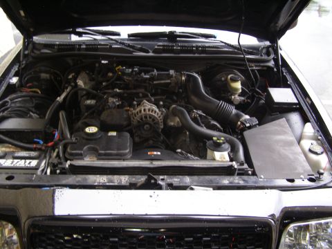 2003 Ford Crown Victoria - View of the engine compartment, showing various mechanical parts and hoses.