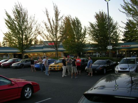 2007 Mazda 3 - Car enthusiasts meet up in a parking lot with several vehicles on display.