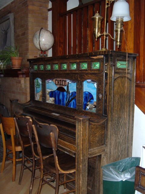 1998 BMW R1100GS ABS - Antique upright piano with stained glass panels and a globe on top.