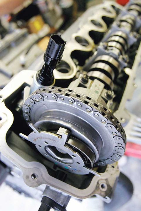 2007 Ford Mustang - Detailed view of an engine's internal components, focusing on the timing chain and camshaft mechanism.
